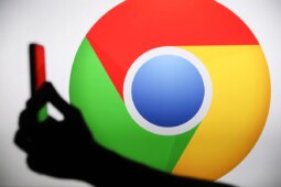 The Chrome logo displays on a screen with a person holding a phone.